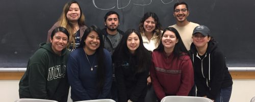 An image of the previous 2019 - 2020 Carter Huggins Community Development and Social Justice Cohort smiling together indoors.