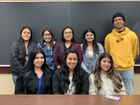 Click to show details - 20s - 7 group of students in front of a blackboard