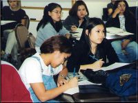 Click to show details - 90s - 11 students listening and taking notes