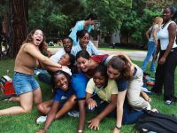 Click to show details - 90s - 5 students playing on the grass